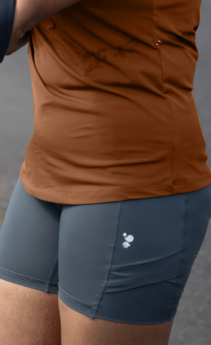 Women’s grey high-performance running tights with 4 side pockets (phone pocket) — sweat-wicking, active shorts for trail and gym workouts.